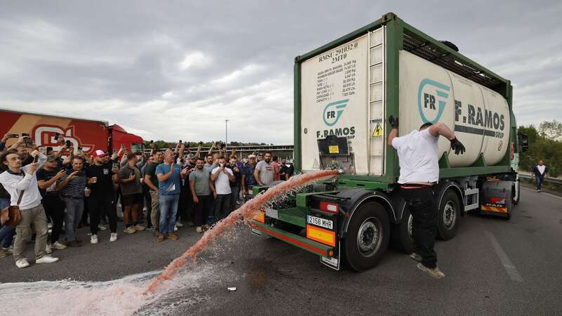 Dramatic photos captured the wine flowing into the street (Image: GUILLAUME HORCAJUELO/EPA-EFE/REX/Shutterstock)