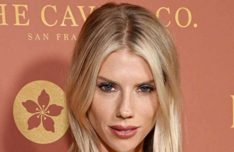 Baywatch star Charlotte McKinney stuns at event in figure-hugging gold dress