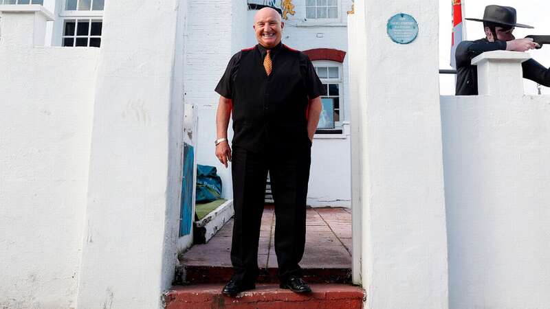 David Courtney poses for photos in his house 