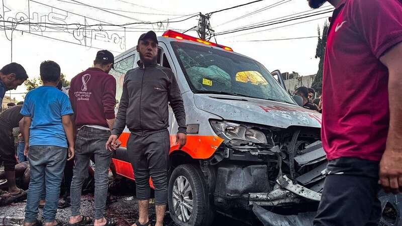 People gather around an ambulance damaged in a reported Israeli strike (Image: AFP via Getty Images)