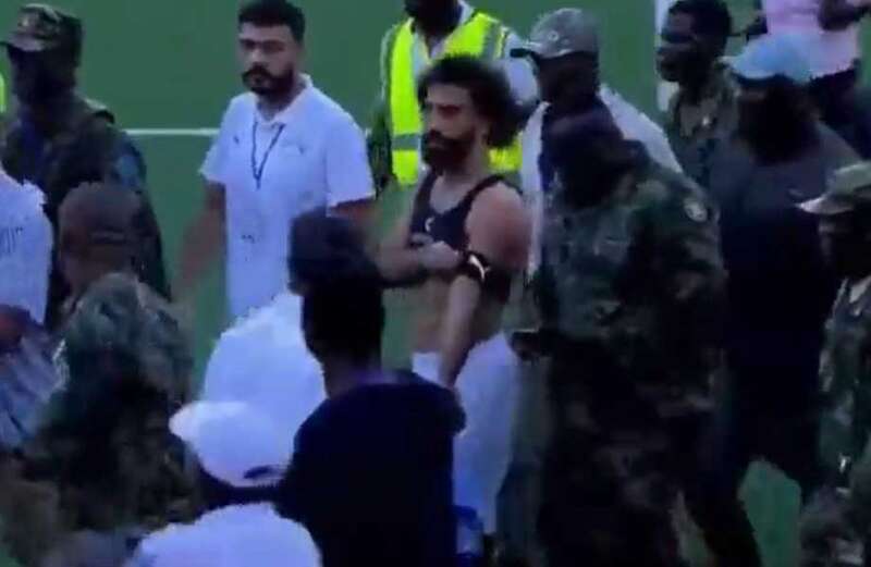 Liverpool star appeared shaken as he was marched off by soldiers during a 2-0 win over Sierra Leone