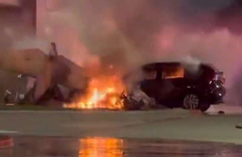 Flames spread to a nearby car after the horrific wreck