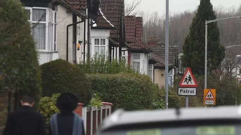 Cars are parked outside a school at drop-off time (file image) (Image: MEN MEDIA)