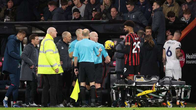 Referee Simon Hooper takes the ball after Bournemouth vs Luton was suspended