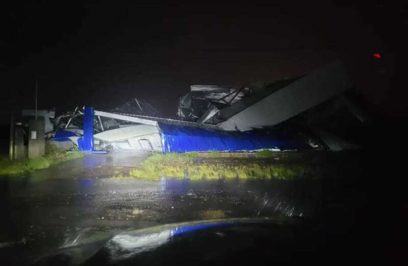 Torrential rain was falling from a charcoal grey sky with gusting winds lifting up canopies in an Argentine port city