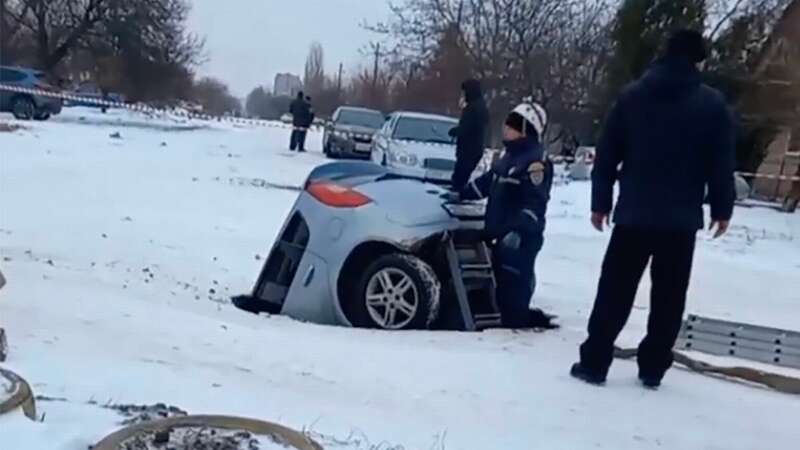 Woman spends several minutes underground after car sucked up by giant sinkhole