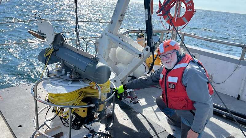 Crew member Paul with the remote submersible during an expedition to the wreck site (Image: Credit: NW Shipwreck Alliance via Pen News)