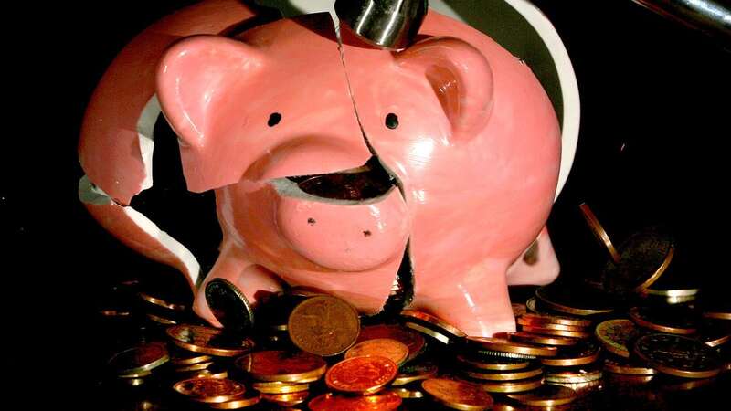 A traditional piggy bank is smashed open with a hammer. (Image: PA Archive/PA Images)