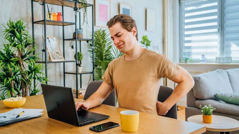 Have you ever considered whether bad posture could be to blame for back pain? (Image: Getty Images)