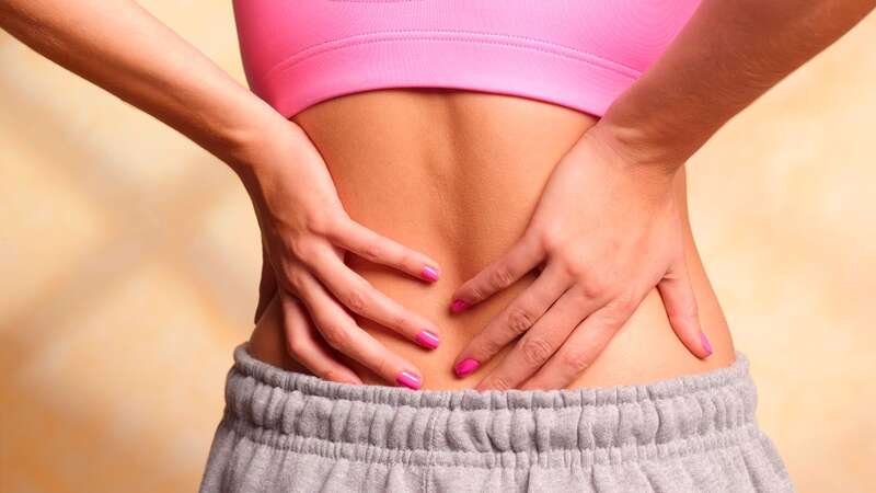 Backache is a symptoms of IBS - which effects one in five adults in the UK (stock photo) (Image: Getty)