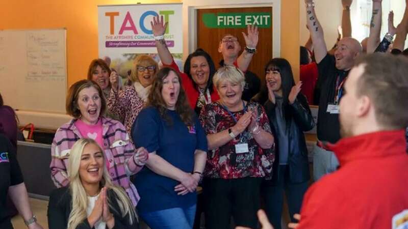 Volunteers at the charity celebrate their win