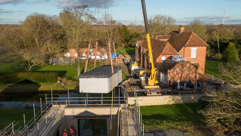 A spa pool is removed from the home of Hannah Ingram-Moore (Image: PA)