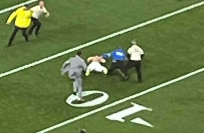 The two men removed their shirts before being tackled to the ground by security