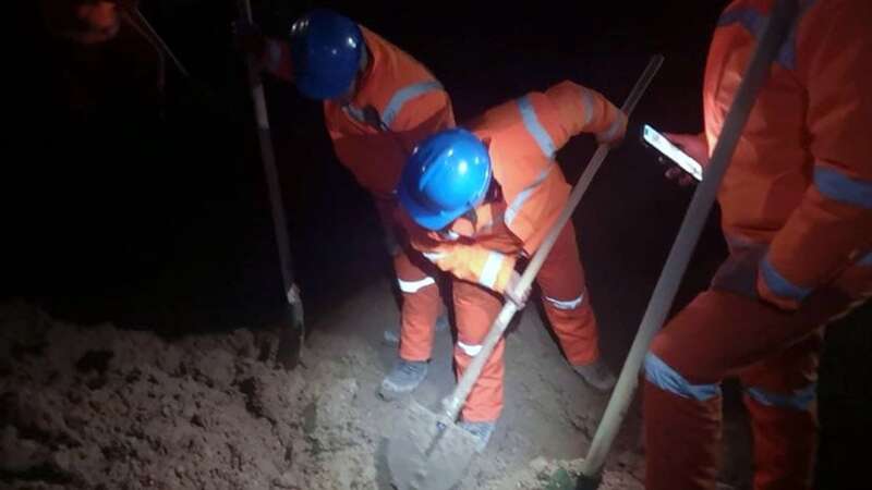 Rescuers dig in an attempt to reach their trapped friends beneath the earth (Image: Xinhua/REX/Shutterstock)