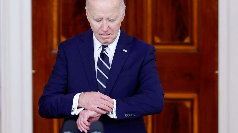 President Joe Biden looks at his watch as he arrives to give remarks with King of Jordan Abdullah II ibn Al Hussein at the White House on February 12 (Image: Getty Images)