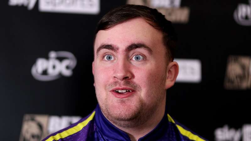 Luke Littler is regularly spotted on his phone away from the oche (Image: Shane Healey/ProSports/REX/Shutterstock)