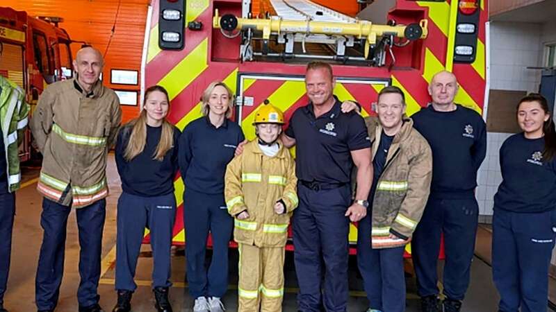 Blaine Beattie is reunited with the firefighters who saved him (Image: CDDFRS/SWNS)