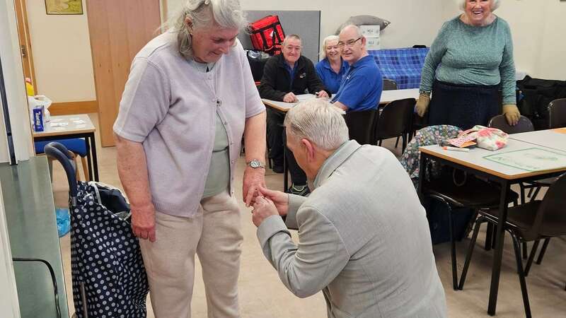 Dennis Buck proposing to Jenny Grimmer at their weekly Age UK centre game session (Image: Age UK North East Lincolnshire/SWNS)