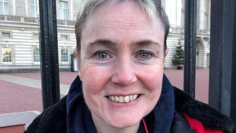 Lisa Murray-Lang with Spud in a vial around her neck outside Buckingbham Palace (Image: Lisa Murray-Lang/SWNS)