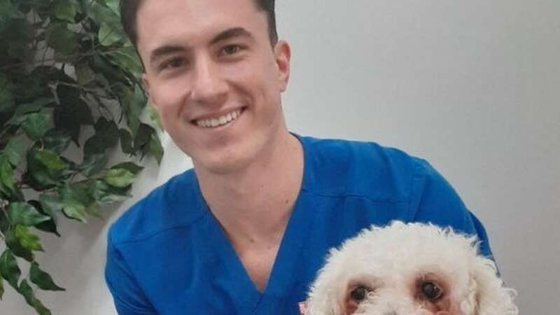 Vet Matheus with 13-year-old Charlie and the 133 coins that were removed from his stomach (Image: Thameswood Veterinary Clinic/SWNS)