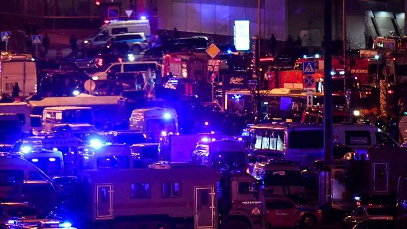 Emergency services personnel and law enforcement officers are seen outside the Crocus City Hall concert hall following the shooting incident in Krasnogorsk (Image: AFP via Getty Images)