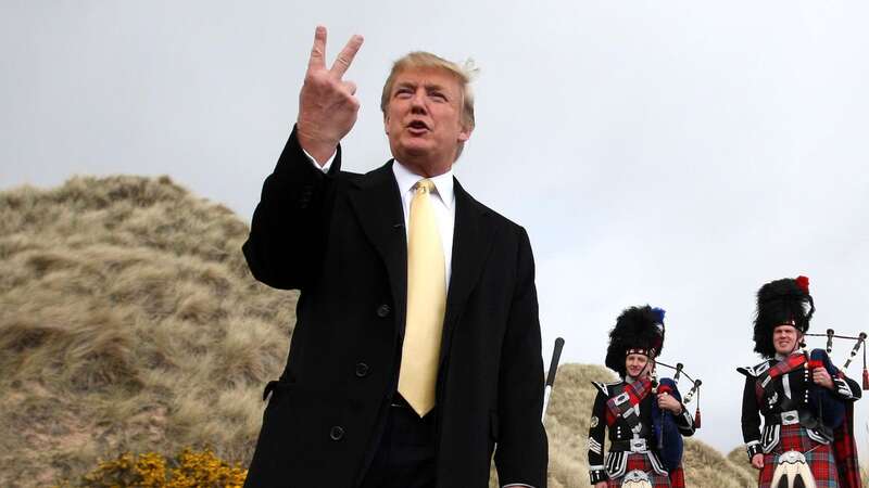 Donald Trump humorously gives a two fingered gesture to the media on the Menie Estate, where his controversial luxury golf resort was to be built (Image: PA)