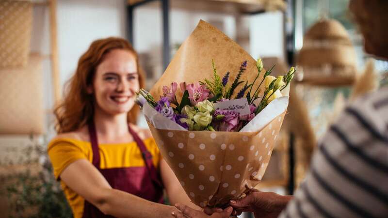 A florist holds a bunch of fresh flowers (Image: Getty Images)