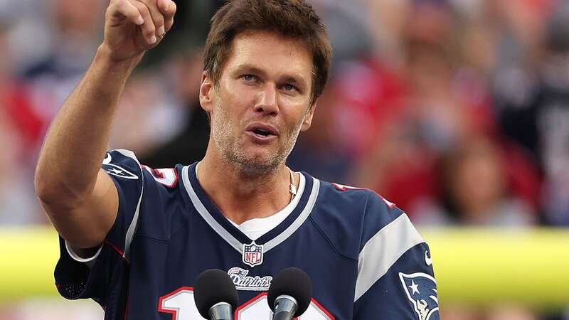 FOXBOROUGH, MASSACHUSETTS - SEPTEMBER 10: Former New England Patriots quarterback Tom Brady speaks during a ceremony honoring him at halftime of New England