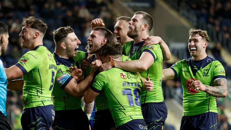 Warrington Wolves Danny Walker (hidden) celebrates scoring his side