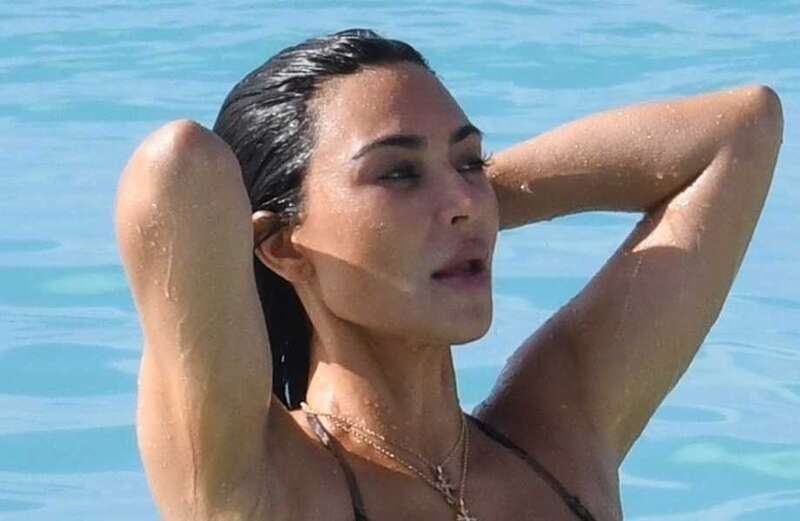 Both Kardashian sisters donned barely-there, snake-skin bikinis for the beach day