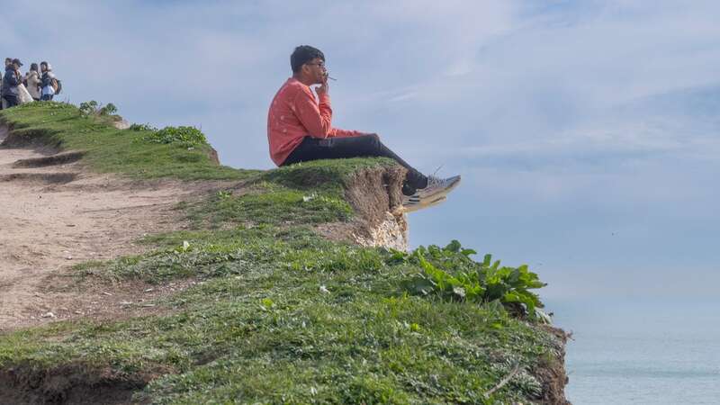 A sightseer diced with death on a clifftop on Easter Sunday (Image: JJ Waller / SWNS)