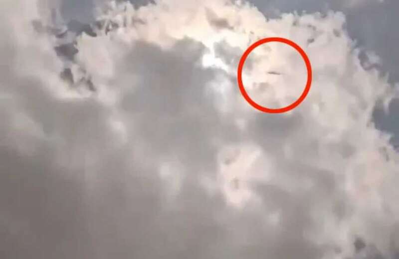 Watch the incredible video above show the mysterious dark shape moving amongst the clouds