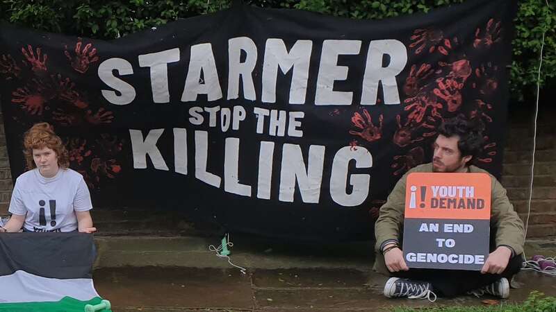 A small group of activists unfurled a Palestinian flag and banner outside the Labour leader