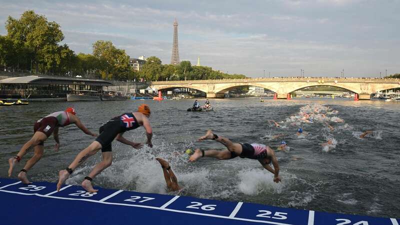 Triathlon athletes dive into The Seine river (Image: BERTRAND GUAY/AFP)