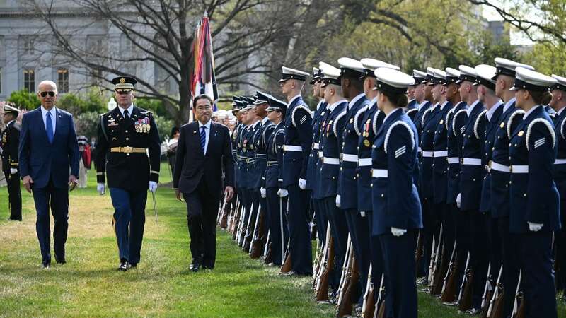 US President Joe Biden and Japanese Prime Minister Fumio Kishida review troops (Image: AFP via Getty Images)