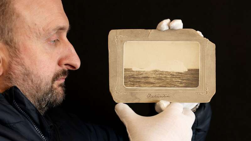 Auctioneer Andrew Aldridge with the rare photo of the iceberg (Image: CorinMesser/BNPS)