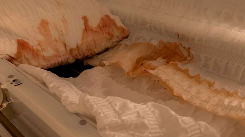 What appears to be blood staining the casket at Two Pines Funeral Home, which was left abandoned (Image: mediadrumimages/Leland Kent)