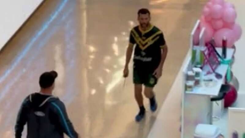 Joel Caluchi, 40, right, is confronted during the knife attack at a busy Sydney shopping centre