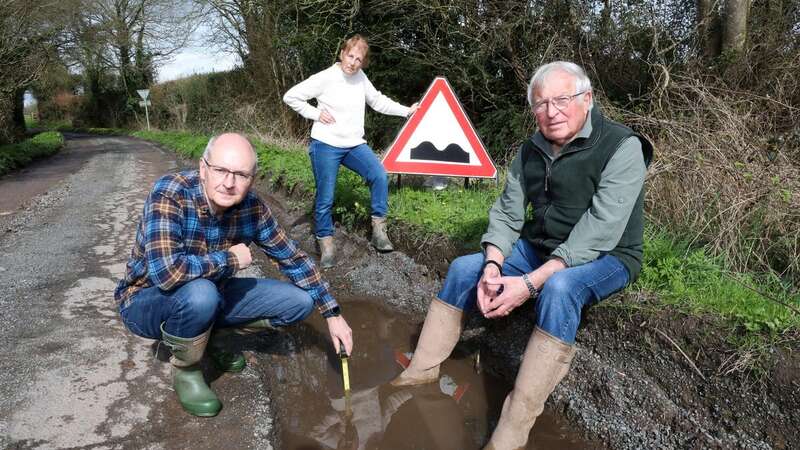 Kevin Harlock (l), Caroline Wilkie (c) and Ronnie Wilkie feel they are cut off from the rest of the world because of potholes (Image: Hereford Times / SWNS)