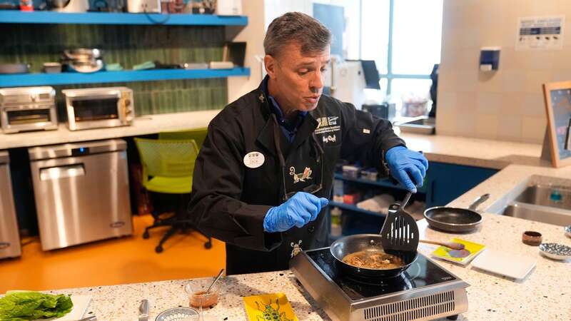 Zach Lemann, curator of animal collections for the Audubon Insectarium, prepares cicadas for eating at the insectarium in New Orleans (Image: Copyright 2024 The Associated Press. All rights reserved.)