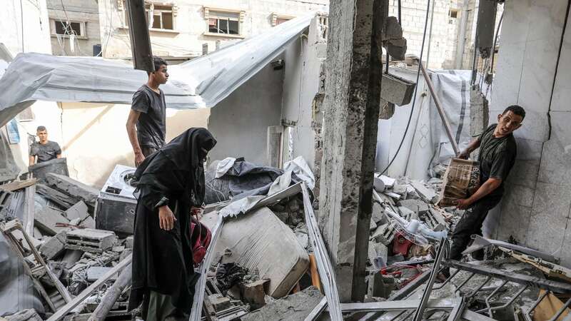 Palestinian residents living in the area inspect the destroyed houses (Image: Anadolu via Getty Images)