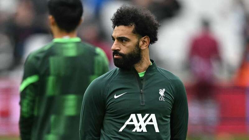 Mohamed Salah could not have looked more disinterested after being dropped to the bench against West Ham (Image: AFP via Getty Images)