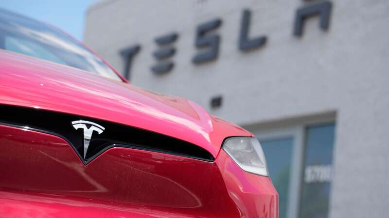 A Model X sports-utility vehicle sits outside a Tesla store in Littleton, Colo. Shares of Tesla stock rallied this week after Elon Musk paid a surprise visit to Beijing and reportedly won tentative approval for its driving software (Image: Copyright 2023 The Associated Press. All rights reserved.)