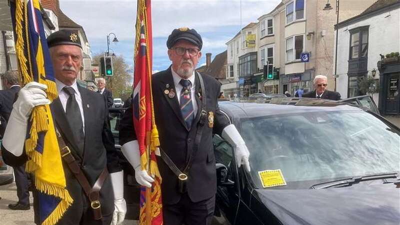 Representatives of the British Legion by the funeral car with the parking ticket (Image: Rev. Lindsay Hammond/SWNS)