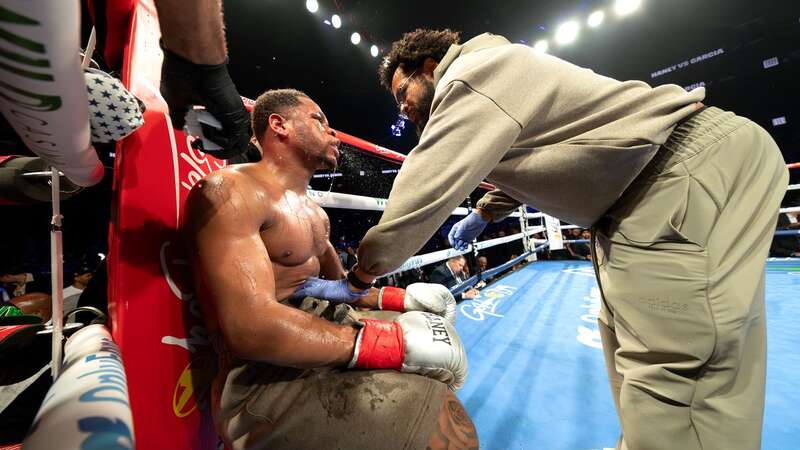 Devin Haney (gray trunks) receives instructions from his father Bill Haney in between rounds during their WBC Super Lightweight title bout against Ryan Garcia. (Image: Getty Images)