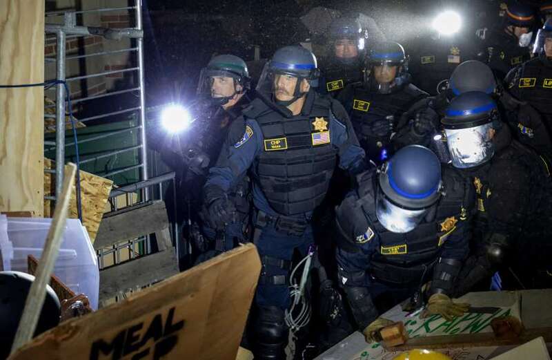 Multiple bangs can be heard in the video as police move in to dismantle the mini village of tents