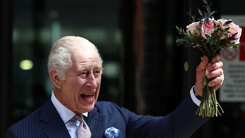 The King quietly let royal fans know he was wearing a pink dinosaur tie (Image: AFP via Getty Images)