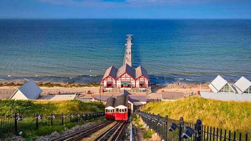 The funicular railway runs up and down the cliffs between the town and the beach (Image: Getty)