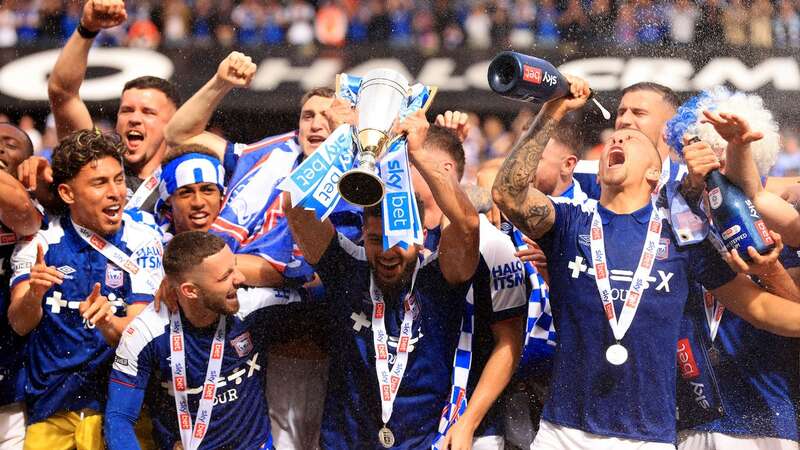 Players of Ipswich Town celebrate with the trophy after promotion to the Premier League (Image: Stephen Pond)