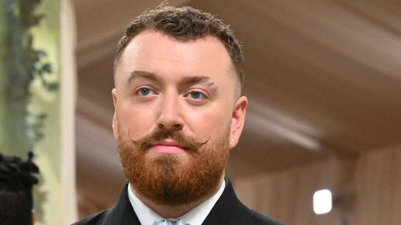 Sam Smith rocked the Met Gala last night sporting a shimmering sheer skirt and dapper handlebar moustache (Image: AFP via Getty Images)